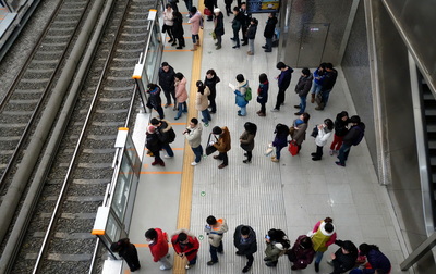 queue to get on a train in japan